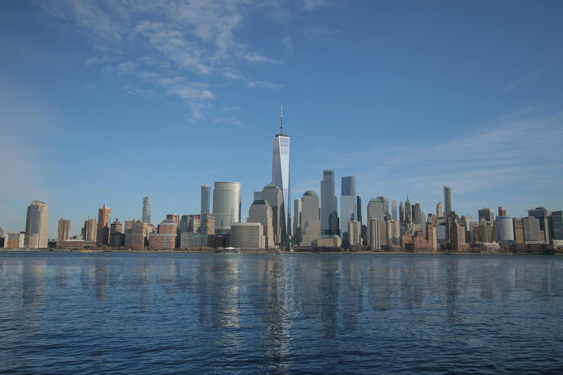 New York City skyline reflected across the water.