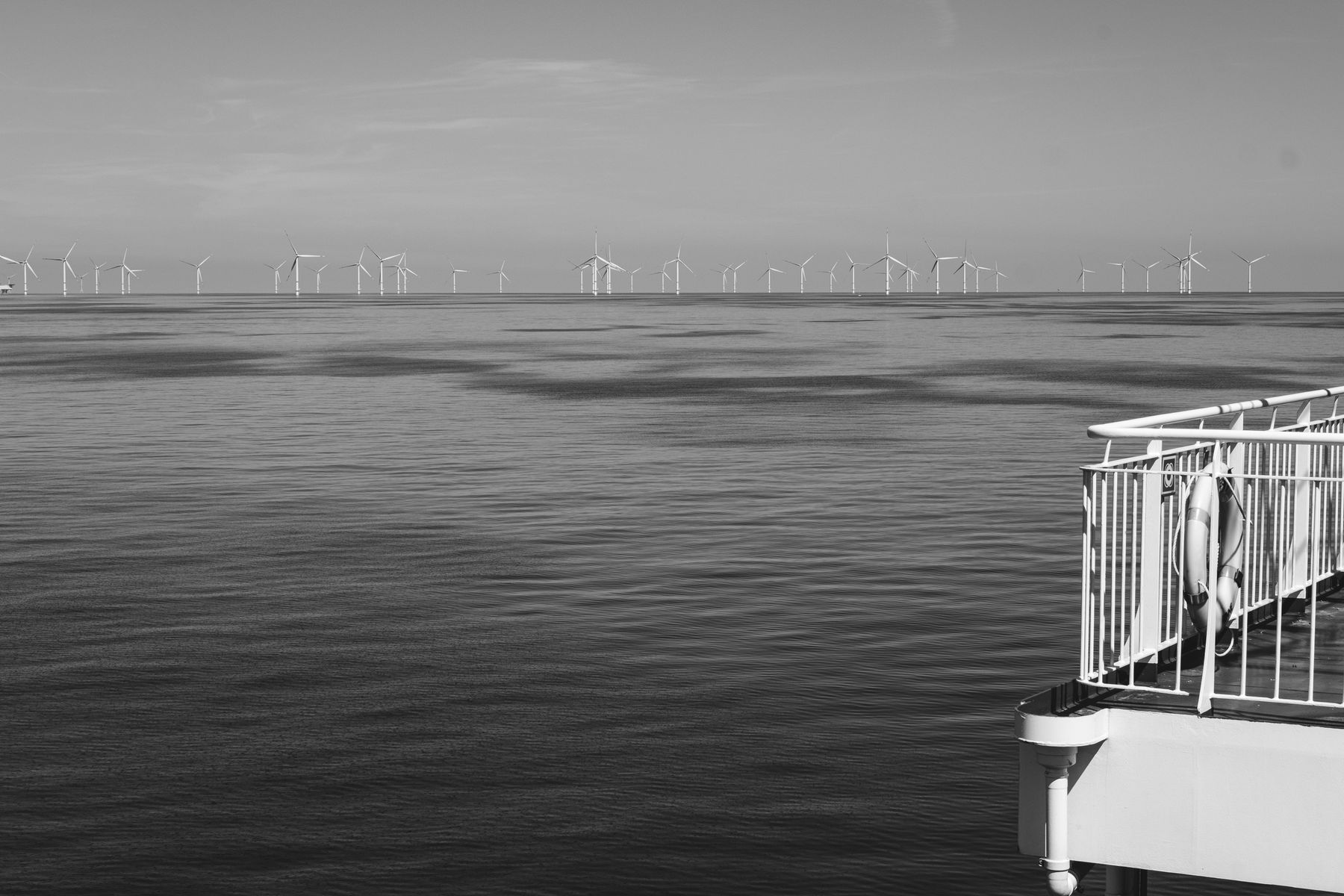 Offshore wind turbines over water representing clean energy development.